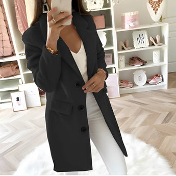 
Image of a woman wearing a long black oversized blazer in a tailored chic fashion style. The blazer features long sleeves and a structured collar, paired with a dress shirt. The woman is gesturing with her hand near the waist and is wearing eyewear. The blazer is in a 5XL size, providing a stylish and comfortable fit.