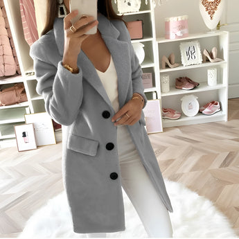 Women's long gray oversized blazer featuring a tailored chic fashion design with a structured collar and long sleeves, photographed on a white background.