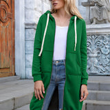 Woman wearing a long blue oversized zip-up hoodie with the hood up, showcasing its streetwear style. She is standing outside, possibly in an urban environment, wearing sunglasses that add to the casual and trendy look. The hoodie features long sleeves and a relaxed fit, making it ideal for comfort and style.