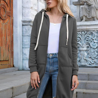 Women's long blue oversized zip-up hoodie in urban streetwear style, modeled by a person wearing sunglasses.