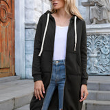 Women's long blue oversized zip-up hoodie styled with urban streetwear elements, featuring a relaxed fit with long sleeves. Model is accessorizing with black sunglasses.