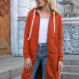 Women's long blue oversized zip-up hoodie styled in urban streetwear fashion, worn by a woman accessorized with sunglasses.