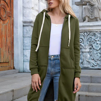 Women's long blue oversized zip-up hoodie styled as urban streetwear, featuring a relaxed fit with full-length sleeves. A person wearing the hoodie is accessorized with black sunglasses, emphasizing a fashionable street style look.