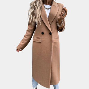 Elegant women's long camel wool coat in double-breasted style, ideal for chic winter wear. The coat features a structured design with full sleeves and a fitted waist, providing a sophisticated and warm outerwear option.