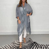 
A women's long flowy grey kimono cardigan in a size 5XL, featuring wide sleeves and a lightweight fabric suitable for versatile summer wear. The cardigan drapes elegantly, reaching knee-length, and is showcased against a simple white background.
