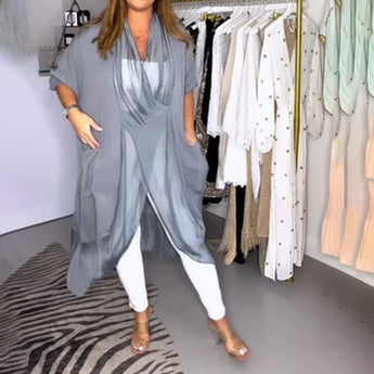 A stylish women's long flowy grey kimono cardigan hanging on a clothes hanger, showcasing its versatile summer wrap design with wide sleeves and elegant fashion details.