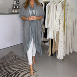 Women's grey kimono cardigan with long flowy sleeves, styled for a versatile summer look.
