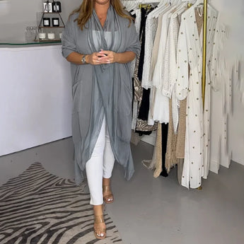 Women's grey kimono cardigan with long flowy sleeves, styled for a versatile summer look.