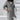 Woman wearing a gray 5XL long asymmetric zip hoodie featuring a stylish design with a collar and long sleeves.
