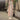 Women's long pink cardigan in size 3XL displayed on a mannequin or model, set against a room background with houseplants and flooring, showcasing cozy spring fashion suitable for layering.