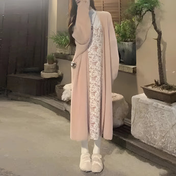 Women's long pink cardigan in size 3XL displayed on a mannequin or model, set against a room background with houseplants and flooring, showcasing cozy spring fashion suitable for layering.