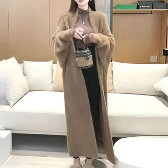 Women's long brown cardigan in 3XL size, featuring a cozy design ideal for spring fashion layering, shown draped on a white furniture background.