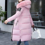 Women's long puffer jacket in roza color, featuring a fur-lined hood and insulated design. The jacket is styled with long sleeves and extends to the waist.