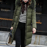 Women's green long puffer jacket with fur hood, designed for winter wear, shown in a standing position. The jacket features insulated material for warmth, long sleeves, and a length that reaches knee to thigh. Size 3XL.