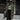 Women's green long puffer jacket with fur hood, designed for winter wear, shown in a standing position. The jacket features insulated material for warmth, long sleeves, and a length that reaches knee to thigh. Size 3XL.