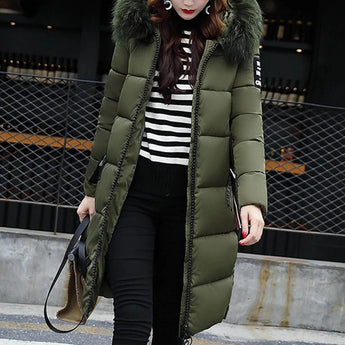 Women's green long puffer jacket with fur hood, designed for winter wear, shown in a standing position. The jacket features insulated material for warmth, long sleeves, and a length that reaches knee to thigh. Size 3XL.