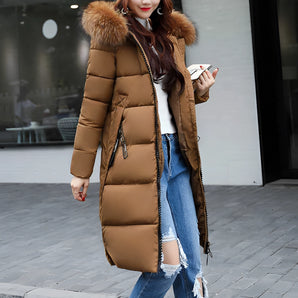Women's long brown puffer jacket with an insulated, fur-lined hood, suitable for winter. The coat is shown in a 3XL size, featuring long sleeves and a waist-length design.