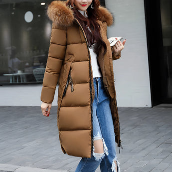 Women's long brown puffer jacket with an insulated, fur-lined hood, suitable for winter. The coat is shown in a 3XL size, featuring long sleeves and a waist-length design.
