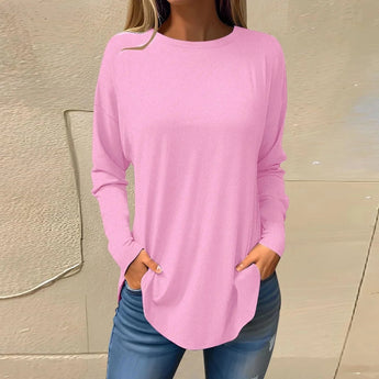 Women's long-sleeve tunic in a soft pink shade, casual and lightweight, designed for a comfortable fit with a relaxed neckline and flowing waist, suitable for cooler weather.
