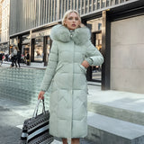 Women's long winter coat in green, 3XL size, featuring a quilted design with insulation for warmth, a fur-lined hood, and long sleeves.