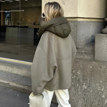 Women's luxury oversized green high-collar hoodie with long sleeves, showcasing an urban fashion style. The hoodie is designed to be stylish and comfortable, with a high collar and a relaxed fit suitable for casual wear.