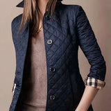 
Dark blue women's luxury quilted slim fit jacket featuring long sleeves, a stylish collar, and button detailing, suitable for designer fashion.