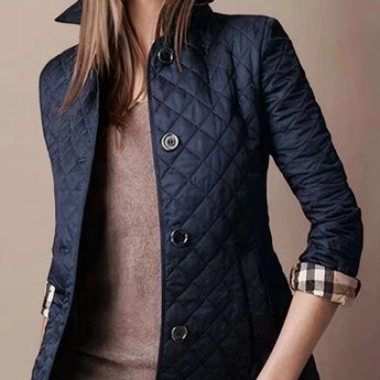 
Dark blue women's luxury quilted slim fit jacket featuring long sleeves, a stylish collar, and button detailing, suitable for designer fashion.
