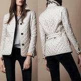 Women's white quilted slim fit jacket, featuring designer fashion elements, with a focus on the shoulders and waist, showcasing long sleeves and a high-quality finish, suitable for stylish outerwear.