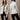 Women's white quilted slim fit jacket, featuring designer fashion elements, with a focus on the shoulders and waist, showcasing long sleeves and a high-quality finish, suitable for stylish outerwear.