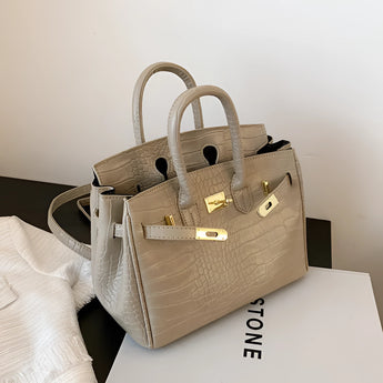 Luxurious women's designer tote handbag crafted from white crocodile leather with a light khaki hue. The bag features a rectangular shape, suitable for shoulder carrying, exuding elegance and fashion-forward design.