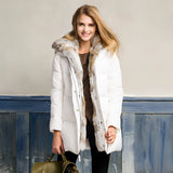
A white women's luxury puffer jacket in size 2XL featuring a fur-lined hood, highlighted by its full sleeves and waist-length design, ideal for winter wear.