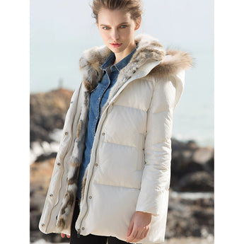 Women's luxury white puffer jacket featuring a fur-lined hood, with long sleeves and a fitted waist, designed for winter wear.