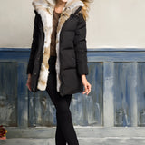 Women's white puffer jacket with a fur-lined hood, featuring long sleeves and a fitted waist, designed for winter wear.