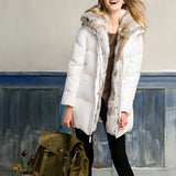 Women's luxury white puffer jacket with fur hood, featuring long sleeves and a plush, warm design suitable for winter.