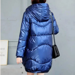 Women's metallic blue hooded puffer jacket, insulated and lightweight, featuring long sleeves, a fitted waist, and a high collar.