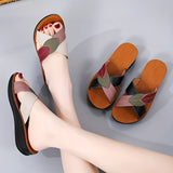 Women's multicolor leather wedge heel sandals with open-toe design, showcasing stylish and comfortable footwear on a model's legs and feet.