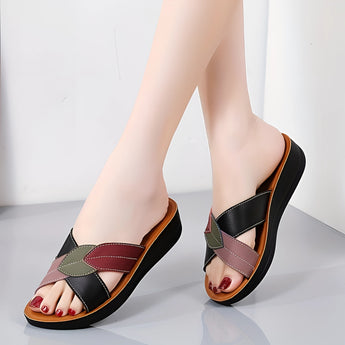 Women's multicolor leather wedge heel sandals, stylish and comfortable with an open-toe design, displayed on a model's feet.