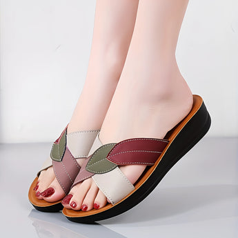 Women's multicolor leather wedge heel sandals with open-toe design, stylish and comfortable, worn by a person showing legs and feet.