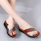 Women's multicolor leather wedge heel sandals with open-toe design, shown on a model's feet, highlighting the stylish and comfortable fashion footwear.