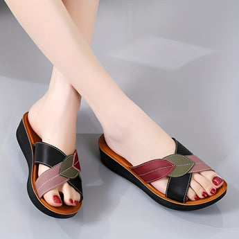 Women's multicolor leather wedge heel sandals, stylish and comfortable, shown on a model wearing a dress.