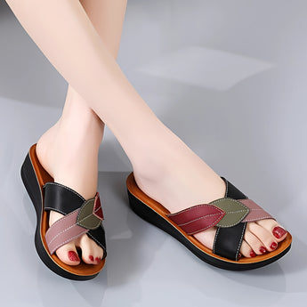 Women's multicolor leather wedge heel sandals, stylish and comfortable, open-toe design, shown on a model's feet.