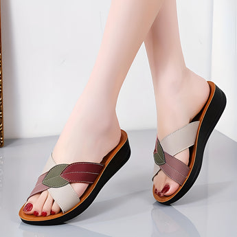Women's multicolor leather wedge heel sandals, stylish and comfortable with an open-toe design, displayed on a model's feet.