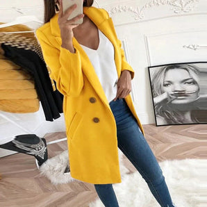 Women's mustard yellow wool coat with long sleeves and a stylish design featuring a collar, covering the waist and extending to the thighs, modeled by a person wearing eyewear.