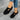 Women's black slip-on walking shoes with a breathable mesh upper, lightweight design, suitable for casual or sportswear.