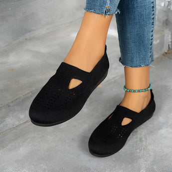 Women's black slip-on walking shoes with a breathable mesh upper, lightweight design, suitable for casual or sportswear.