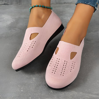 Women's navy blue breathable slip-on walking shoes made with lightweight mesh material, shown on feet.