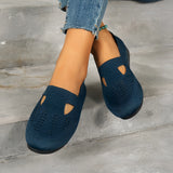 Women's navy blue breathable slip-on shoes featuring a lightweight mesh design, shown worn with denim pants.