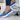 Women's navy blue buckle loafer sneakers with platform sole, showcasing the shoe's design and style.