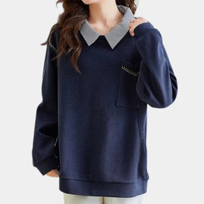 Women's navy blue pullover sweater featuring a contrasting collar and a pocket, designed with long sleeves and a comfortable, relaxed fit.