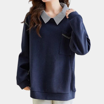 Women's navy blue pullover sweater featuring a contrasting collar and a pocket, designed with long sleeves and a comfortable, relaxed fit.
